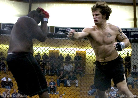 Combat in the Cage 3: Jon Murphy (right) charges at Jerome Smith with fists flying - Photo by Tom DeFazio