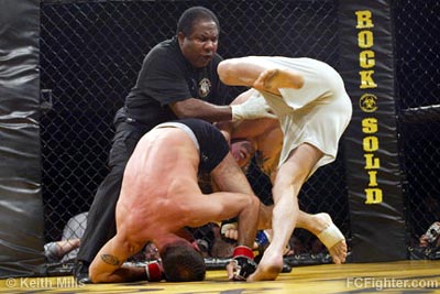 Referee Cecil Peoples pulls Nick Ertle off of Brain Cobb