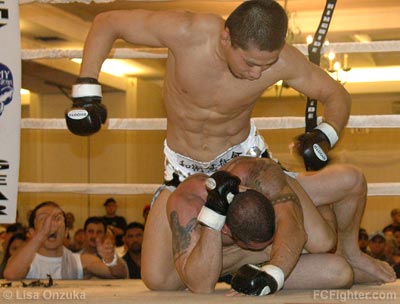 Keita Nakamura looks to soften up Ronald Jhun with punches at Punishment in Paradise 12 - Photo by Lisa Onzuka