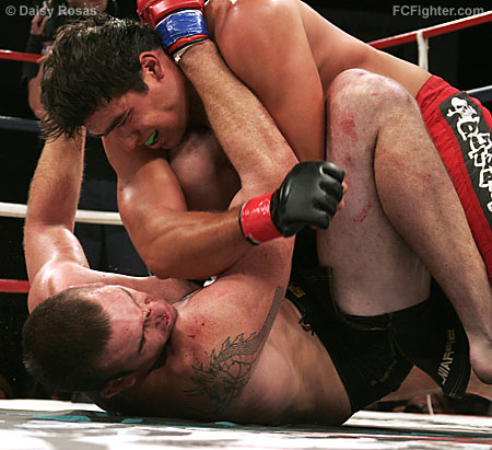 Corn Zwicker pounding on Tom Hubert.