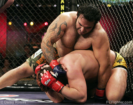 Jimmy Ambriz punching a turtling Justin Eilers