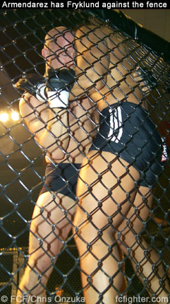 Martin Armendarez has Tony Fryklund up against the fence