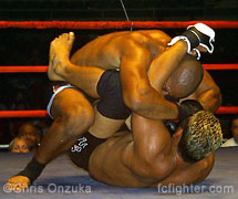 Augie Padekan punching from inside Desmond Miner's guard