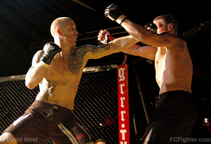Cage Rage Contenders 4: Sol Gilbert (left) punching Darren Guisha - Photo by David West