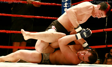 Icon Sport (Mar 31, 2007): Jason Miller (top) pounding on Hector Urbina - Photo by Aaron Meyer