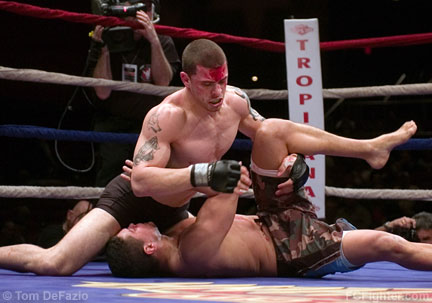 Ring of Combat 14: A bloody Mike Massenzio pounds out a win over Erick Tavares - Photo by Tom DeFazio