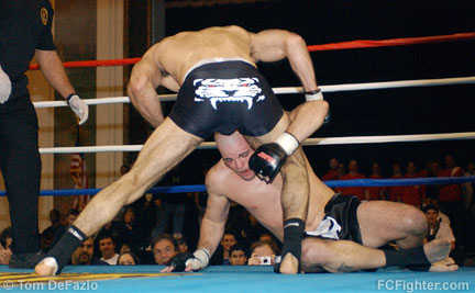 Lyman Good (standing) swings away as Adam Fearon works for a single-leg takedown